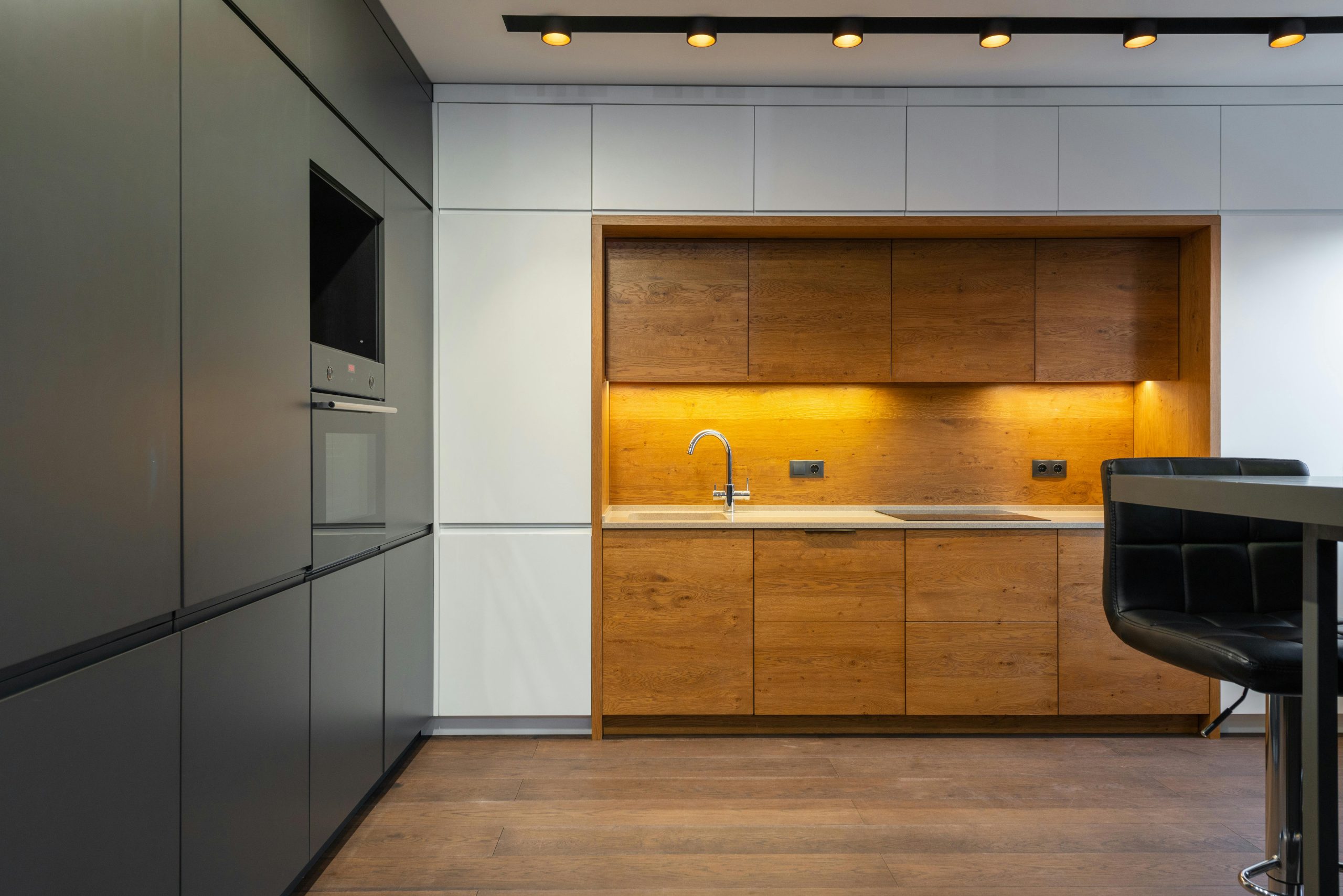 pexels-heyho-8089082 modern handleless kitchen with mood lighting and a wooden floor