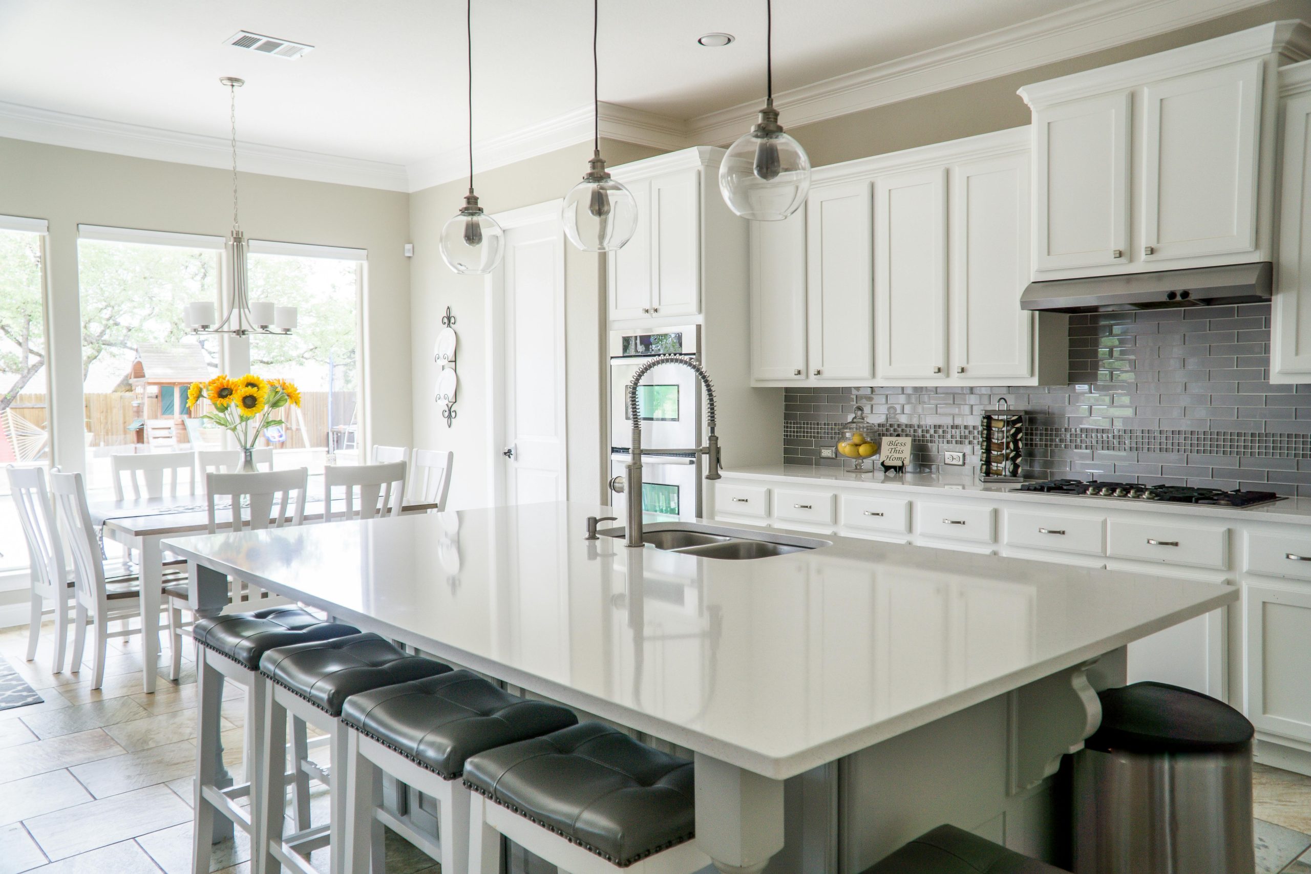 pexels-falling4utah-1080721 (1) a kitchen with white cabinets and a large island