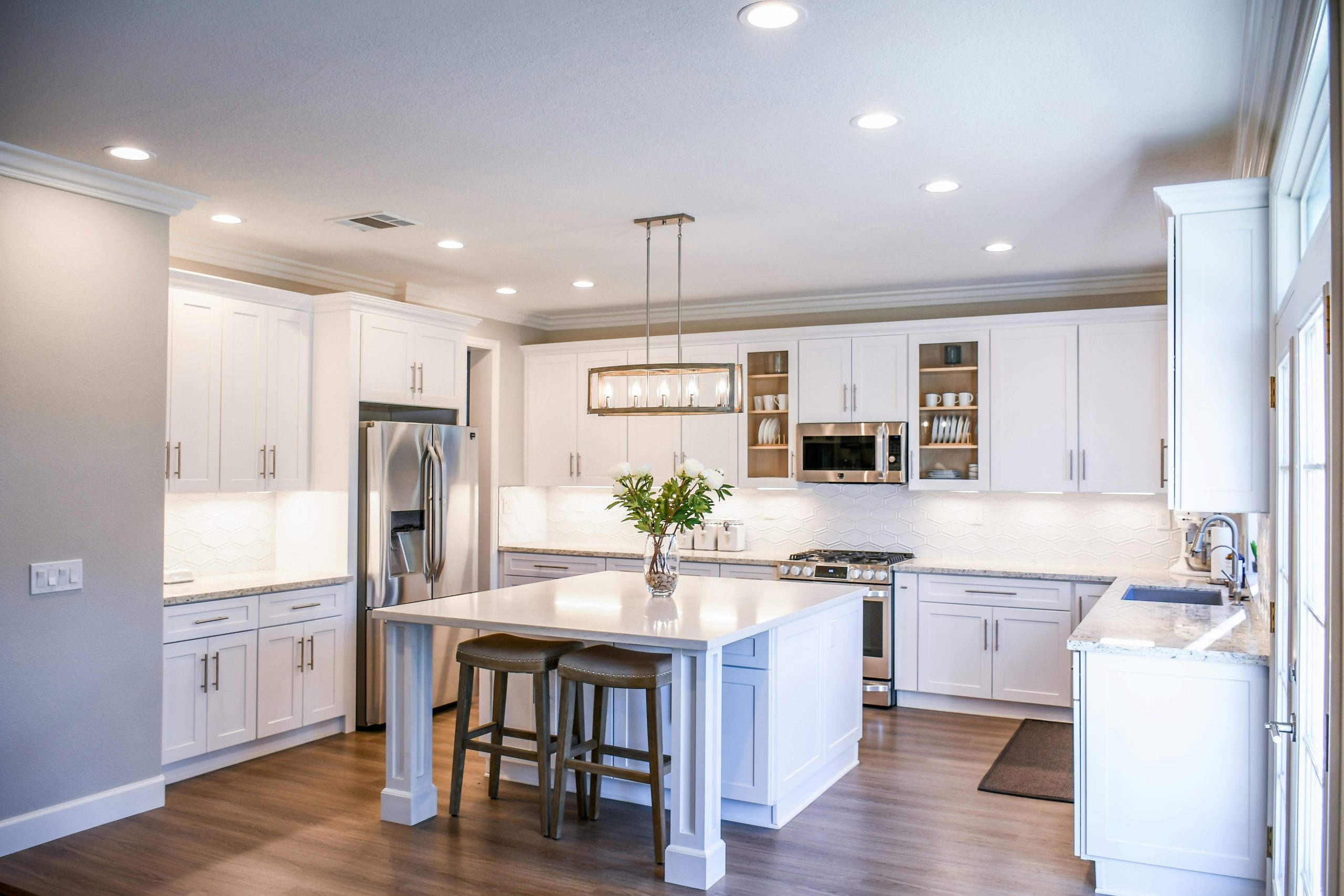 pexels-falling4utah-2724748 a kitchen with white cabinets and a table