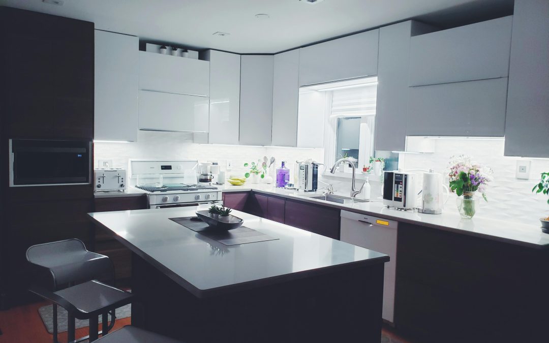 a organised kitchen with a large island and chairs